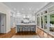 Bright kitchen features a large island, stainless steel appliances, and doors that lead to the outdoor patio at 1579 Queens W Rd, Charlotte, NC 28207