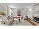 Spacious living room featuring hardwood floors, neutral decor, fireplace, and ample light at 1579 Queens W Rd, Charlotte, NC 28207