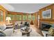 Inviting living room with wood paneling, fireplace, and large windows offering ample natural light and a serene view at 1579 Queens W Rd, Charlotte, NC 28207