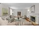 Elegant living room with hardwood floors, neutral tones, fireplace, and large windows at 1579 Queens W Rd, Charlotte, NC 28207