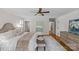 Spacious main bedroom features a ceiling fan, hardwood floors, ensuite access, and a neutral color palette at 1579 Queens W Rd, Charlotte, NC 28207
