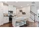 Well-lit kitchen with a large island, pendant lighting, and stainless steel appliances at 1618 Village Grove Ln, Monroe, NC 28110