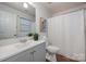 Bathroom featuring a modern vanity, large mirror, and shower with curtain at 1708 Holliford Ct, Charlotte, NC 28215