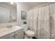 Bathroom featuring a vanity, decorative shower curtain, and framed artwork at 1708 Holliford Ct, Charlotte, NC 28215