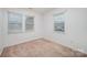 Neutral bedroom with carpet and two windows at 1708 Holliford Ct, Charlotte, NC 28215