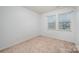 Neutral bedroom with carpet and windows at 1708 Holliford Ct, Charlotte, NC 28215