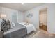 Well-staged bedroom features a cozy bed, tasteful decor, and an en-suite bathroom at 1708 Holliford Ct, Charlotte, NC 28215