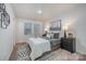 Well-staged primary bedroom featuring two windows, neutral decor, and bedside lamps at 1708 Holliford Ct, Charlotte, NC 28215