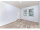 Neutral bedroom with carpet, a window, and a closet door at 1708 Holliford Ct, Charlotte, NC 28215