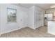 Light and bright entryway adjacent to the kitchen with white walls and light colored floors at 1708 Holliford Ct, Charlotte, NC 28215