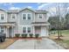 Charming two-story townhome with manicured bushes, green lawn, and a private driveway at 1708 Holliford Ct, Charlotte, NC 28215