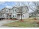 Charming two-story townhome with manicured bushes, green lawn, and a private driveway at 1708 Holliford Ct, Charlotte, NC 28215