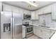 Well-lit kitchen featuring stainless steel appliances, white countertops, and subway tile backsplash at 1708 Holliford Ct, Charlotte, NC 28215