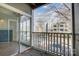 Balcony overlooking a neighborhood street, offering a glimpse of surrounding buildings and vehicles at 2514 Cranbrook Ln # 9, Charlotte, NC 28207