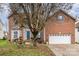 Brick two-story house with a two-car garage and landscaping at 4813 Chesney Nw St, Concord, NC 28027