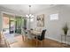 Spacious dining area with glass table, and sliding doors to backyard at 5003 Looking Glass Trl, Denver, NC 28037