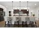 Kitchen island with seating, granite counters, and dark wood cabinets at 5003 Looking Glass Trl, Denver, NC 28037