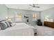 Main bedroom with ceiling fan, large bed, and sitting area at 5003 Looking Glass Trl, Denver, NC 28037