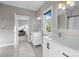 Bright bathroom featuring double sinks, tile flooring, and access to the living room at 511 E Main St, Rock Hill, SC 29730