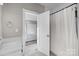 Bathroom features a shower/tub and leads to a bedroom with neutral walls at 511 E Main St, Rock Hill, SC 29730