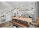 A rustic wood dining table, modern chandelier, and hardwood floors complement the staircase in this dining space at 511 E Main St, Rock Hill, SC 29730