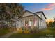 Charming two-story home featuring a covered porch, American flag, and well-manicured landscaping at 511 E Main St, Rock Hill, SC 29730