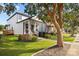 Inviting two-story home featuring a charming front porch, American flag, and well-maintained yard at 511 E Main St, Rock Hill, SC 29730