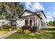 Charming two-story home featuring a covered porch, American flag, and well-manicured landscaping at 511 E Main St, Rock Hill, SC 29730