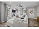 Bright living room featuring a cozy couch, fireplace, and large windows at 511 E Main St, Rock Hill, SC 29730