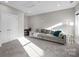 Bright living room featuring gray sofa, plush carpet, double doors, and a desk at 511 E Main St, Rock Hill, SC 29730