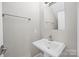 Tastefully appointed powder room featuring a sleek pedestal sink, modern fixtures, and neutral color palette at 511 E Main St, Rock Hill, SC 29730