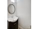 Small bathroom with vanity, round mirror and dark brown cabinet at 6102 Heath Ridge Ct # G, Charlotte, NC 28210