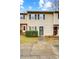 Tan siding townhouse exterior with landscaping and walkway at 6102 Heath Ridge Ct # G, Charlotte, NC 28210