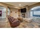 Basement lounge area with stone fireplace and leather seating at 9267 Egret Rdg # 41, Belmont, NC 28012