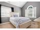 Bright bedroom with a light-colored bed frame and arched window at 9267 Egret Rdg # 41, Belmont, NC 28012