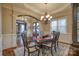 Elegant dining room with hardwood floors and a chandelier, adjacent to the living room at 9267 Egret Rdg # 41, Belmont, NC 28012