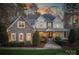 Elegant two-story home with warm lighting at dusk at 9267 Egret Rdg # 41, Belmont, NC 28012