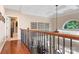 Upstairs hallway with hardwood floors and wrought iron railing at 9267 Egret Rdg # 41, Belmont, NC 28012