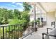 Covered porch with black railings overlooking the backyard at 9267 Egret Rdg # 41, Belmont, NC 28012