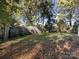 Large backyard with mature trees and a wooden fence at 406 Harris Ln, Monroe, NC 28112