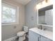 Updated bathroom with white vanity, toilet, and shower at 406 Harris Ln, Monroe, NC 28112