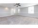 Bright bedroom featuring carpet, ceiling fan, and neutral walls at 406 Harris Ln, Monroe, NC 28112