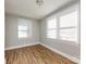 Bright bedroom with hardwood floors and two windows at 406 Harris Ln, Monroe, NC 28112