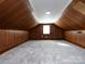 Spacious bonus room with wood paneling and a window at 406 Harris Ln, Monroe, NC 28112