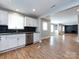 Modern kitchen with white cabinets, granite counters, and stainless steel appliances at 406 Harris Ln, Monroe, NC 28112