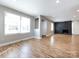 Bright living room featuring hardwood floors, fireplace, and large windows at 406 Harris Ln, Monroe, NC 28112