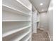 Large walk-in closet with built-in shelving and hanging rods at 406 Harris Ln, Monroe, NC 28112