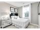 Simple bedroom with a full-size bed, nightstand and window coverings at 5637 Knox Ln # D, Kannapolis, NC 28081