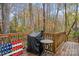 Relaxing outdoor deck featuring a grill, table, and a painted American flag design at 958 Sherwood Cir, Lancaster, SC 29720