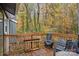 Spacious deck with wooden railing and outdoor furniture surrounded by beautiful trees in the background at 958 Sherwood Cir, Lancaster, SC 29720